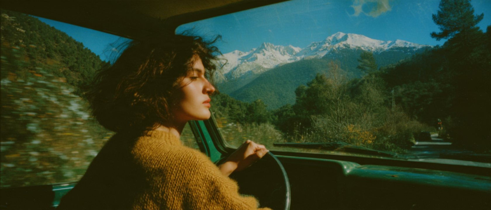 Woman driving through the mountains